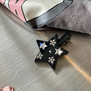 Star-shaped black hair clip with colorful zircon crystals and sparkling rhinestones