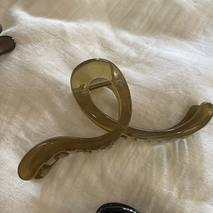 Close-up of translucent jelly hair claw clip with large crossed design and metal spring