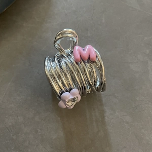 Silver metal flower hair claw clip with pink letter M and purple floral detail