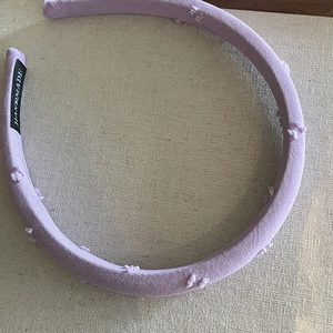 Elegant lavender handmade fabric headband with soft textured decorative pom-pom detailing