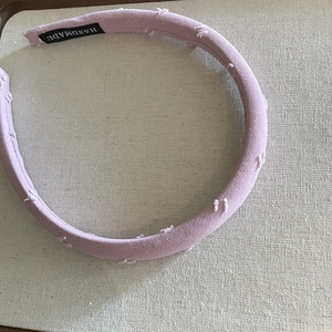 Handmade light pink fabric headband with textured pom-poms for a minimalist elegant look