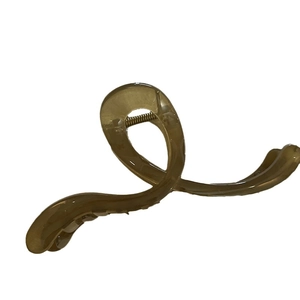 Translucent brown jelly hair claw clip with large streamlined spiral design and metal spring