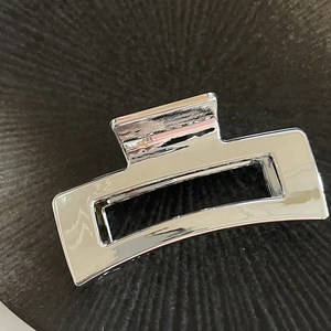 Minimalist silver rectangular hollow metal hair claw clip with mirror finish shine