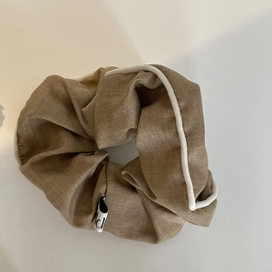 Vintage brown scrunchie with white piping edge and puffy fabric for ponytail styling