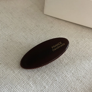 Detail of tortoise shell acetate hair clip with gold France Handmade logo engraving