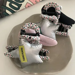 Close-up of padded silver star hair clips with colorful braided rope trim details