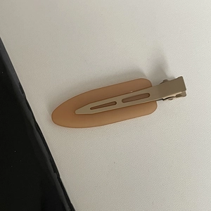Matte jelly beige hair clip with sleek oval plastic finish and a durable metal base
