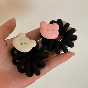 Pink and beige bear phone cord hair ties set with black spiral elastic bands