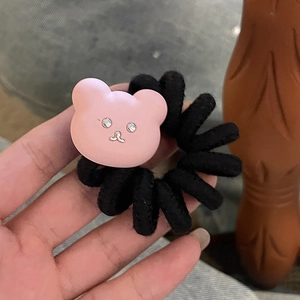 Detail of pink bear charm on black spiral telephone wire hair tie with rhinestone eyes