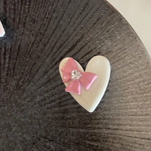 Y2K style heart hair clip with pink bow and crystal stone on a cream base for girls