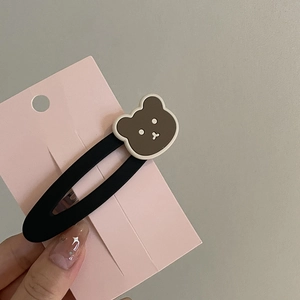 Vintage bear pearl hair clip on pink card held by hand showing the cute design
