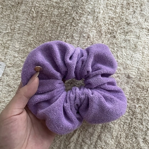 French minimalist purple hair scrunchie in soft towel fabric with a small gold pendant