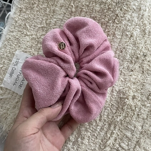Pink towel-textured cotton scrunchie with a gold 'Hand Made' charm and label