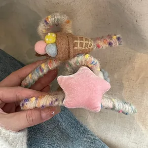 Detail of wool-wrapped hair claw clip with felt ice cream and velvet star decorations