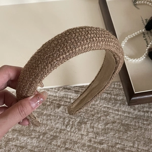 Detailed close-up of khaki tweed padded headband featuring vintage woven texture