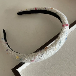 Elegant white tweed headband with colorful rainbow polka dots for a vintage knitted style