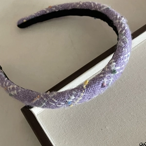 Close-up detail of lavender purple tweed headband with colorful knit fabric texture