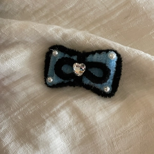 Handmade plush bow hair clip in blue and black with pearls and a heart crystal