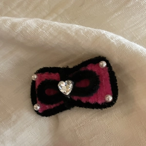Handmade pink and black fuzzy bow hair clip with a crystal heart and pearl accents