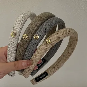 Detailed shot of knitted padded headbands with vintage golden rose flower metal charms