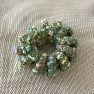 Colorful wool-wrapped spiral telephone wire hair tie with moss green tweed texture