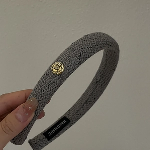 Gray knitted padded headband featuring a vintage gold camellia metal flower charm