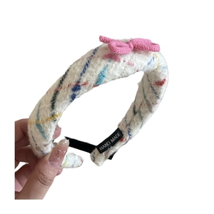 Handmade white tweed headband with colorful accents and a pink knit bow for women