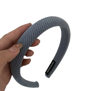 Blue-grey corduroy padded headband with handmade label and vertical striped texture