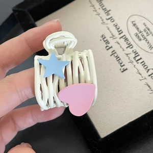 Matte white hair claw clip with blue star and pink heart patterns for women