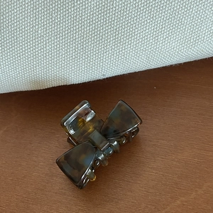 Small tortoiseshell acetate hair claw clip with bow design and elegant amber pattern