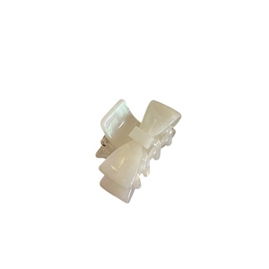 Elegant cream white acetate bow hair claw clip with pearlescent finish for women