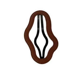 Retro brown leather hair clip with wavy edges and handcrafted stitching detail