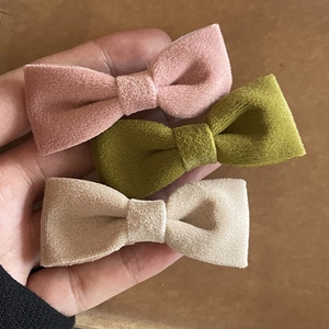 Three-piece velvet bow hair clips in dusty pink, olive green, and beige colors
