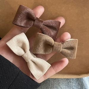 Three-piece set of velvet bow hair clips in coffee, brown, and cream white for women