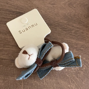 Cute teddy bear denim bow hair tie with brown elastic band on a display card