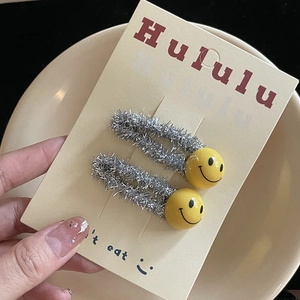 Set of two silver glitter hair clips with bright yellow smiley face charms for girls