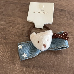 Denim bow hair tie with plush bear and star sequins on a brown elastic band