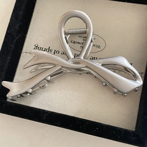 Elegante fermaglio per capelli a fiocco in metallo argento opaco su portagioielli