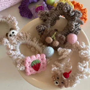 Handmade crochet hair ties with strawberry, cherry and bear decorations in warm colors