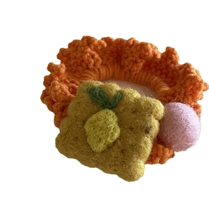 Cute handmade knitted orange hair tie featuring a toast design and pink pom-pom