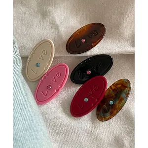 Lot de 6 barrettes ovales en acrylique coloré avec gravure Love et petits strass