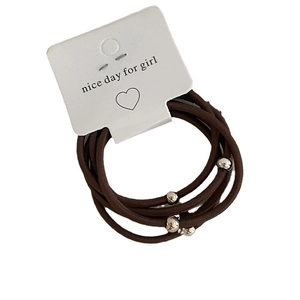 Five-pack of dark brown elastic hair ties with silver metal beads on display card
