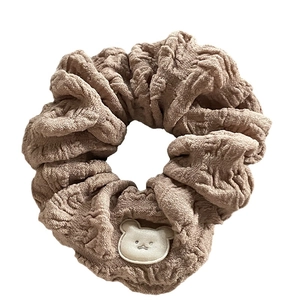 Cute brown fabric scrunchie with white bear cartoon patch in minimalist Korean style