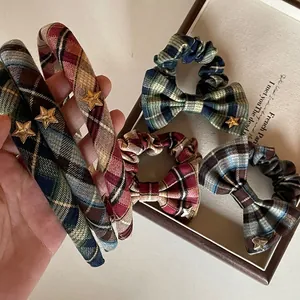 Detail of vintage plaid hairband and scrunchie with golden star metal embellishments