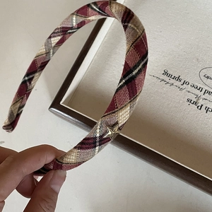 Elegant plaid headband with burgundy pattern and gold star charm in a vintage style