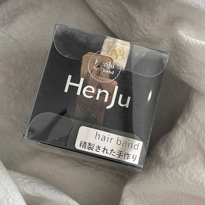 High-elastic black hair ties set in a premium transparent gift box on white fabric