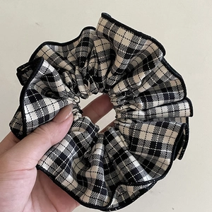 Classic black and white plaid scrunchie with scalloped edges for elegant ponytails