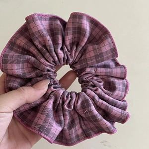 Close-up of purple plaid scrunchie showing fabric texture and woven sewing details