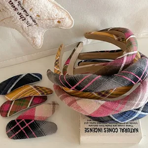 Close-up of pink plaid wool headband and matching hair clip for women's autumn accessories