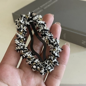 Elegant black and white tweed BB hair clip with gold metallic threads and woven texture